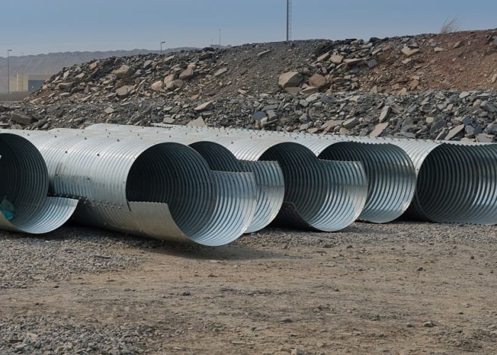 A series of large diameter corrugated culvert lie ready to be installed to divert storm water.